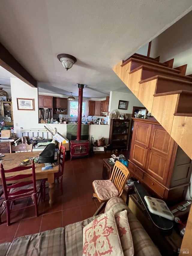 interior space with a wood stove and vaulted ceiling