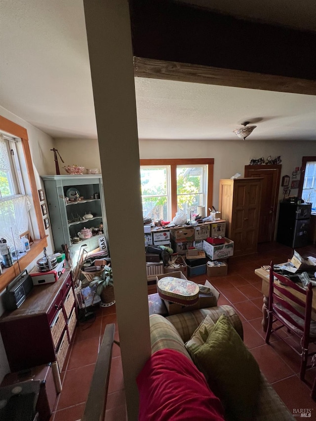 tiled living room with beam ceiling