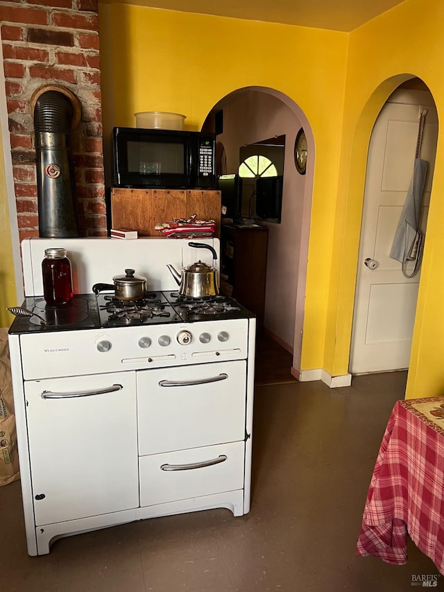 interior space featuring a wood stove and white cabinets