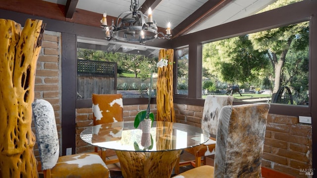 dining area with an inviting chandelier and vaulted ceiling with beams