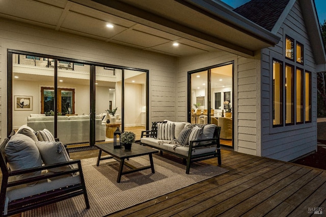 wooden terrace with an outdoor living space