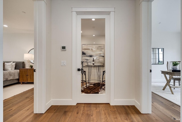 hall with light hardwood / wood-style floors