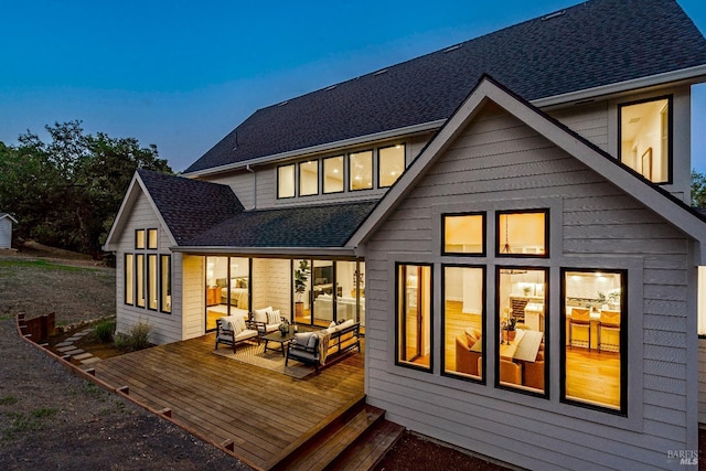 back of house with a wooden deck and an outdoor living space