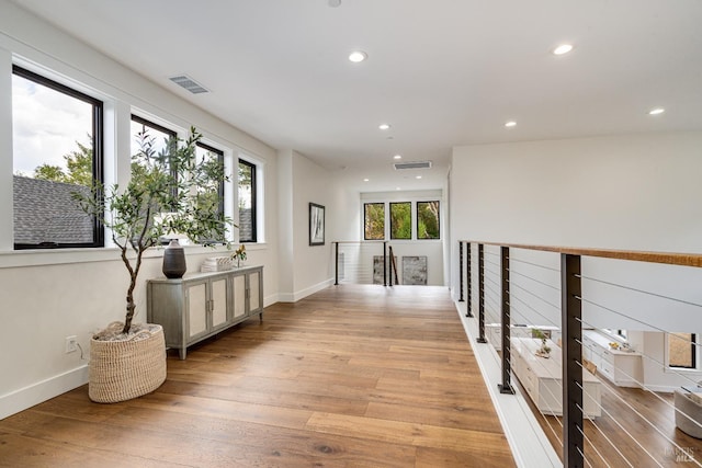 hallway with light hardwood / wood-style floors