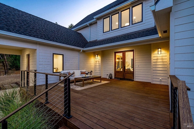 deck at dusk featuring outdoor lounge area