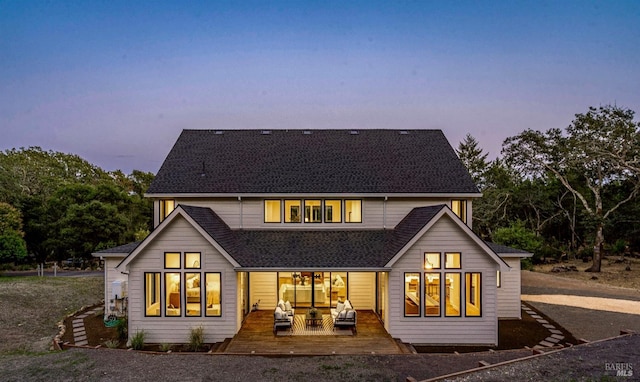 view of back house at dusk