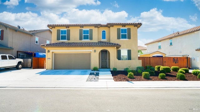 mediterranean / spanish home featuring a garage