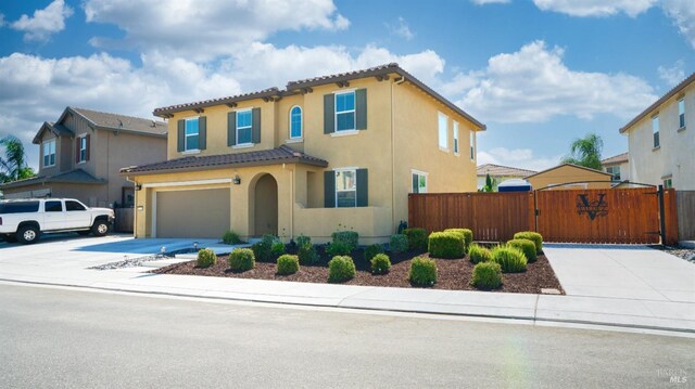 mediterranean / spanish-style house with a garage