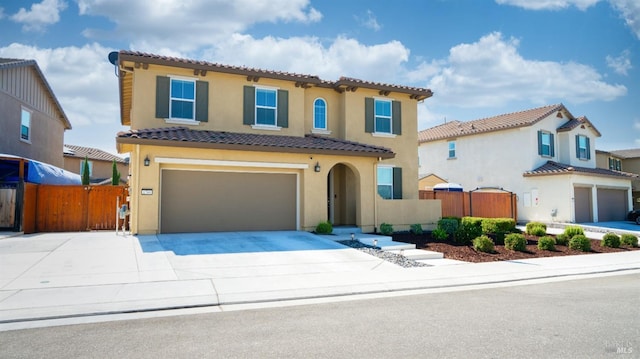 mediterranean / spanish-style house with a garage