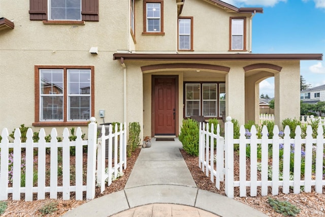 view of exterior entry with a porch