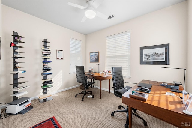 carpeted home office with ceiling fan