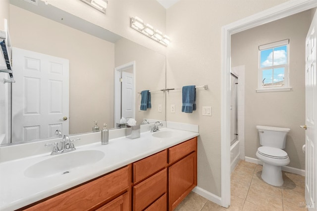 full bathroom featuring vanity, enclosed tub / shower combo, toilet, and tile patterned flooring