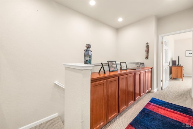 corridor featuring light colored carpet