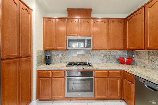 860 Citation Ct, Napa, CA 94559 - kitchen with appliances with stainless steel finishes, light countertops, backsplash, and light tile patterned flooring