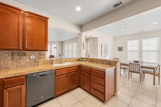 860 Citation Ct, Napa, CA 94559 - kitchen with stainless steel dishwasher, a sink, a peninsula, light countertops, and light tile patterned floors