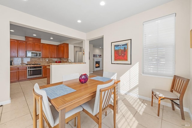 860 Citation Ct, Napa, CA 94559 - dining space with a lit fireplace, light tile patterned floors, baseboards, and recessed lighting