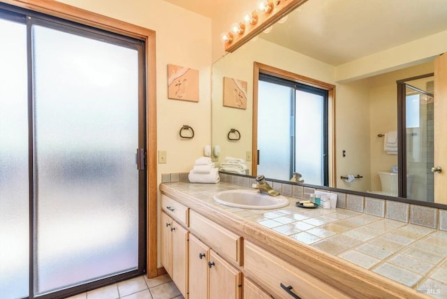 bathroom with tile patterned floors, vanity, and toilet