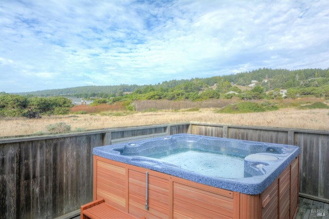 wooden terrace featuring a hot tub