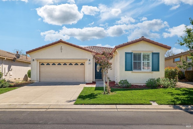 mediterranean / spanish house with a garage and a front lawn