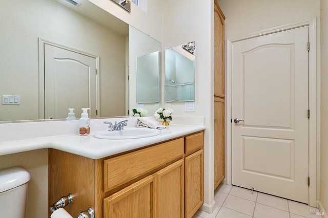 bathroom featuring vanity, toilet, and tile patterned flooring