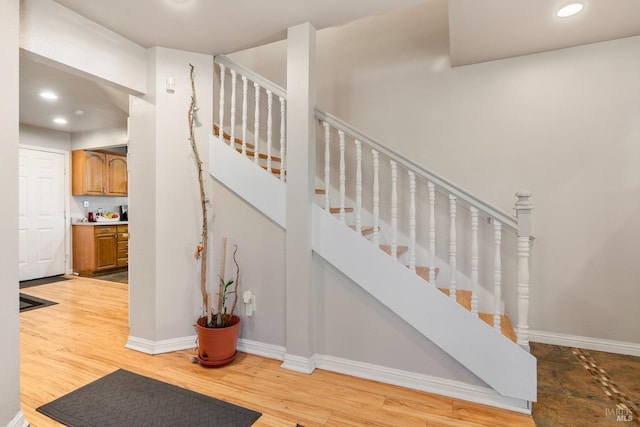 staircase with hardwood / wood-style floors