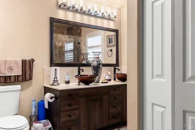 bathroom with toilet and vanity