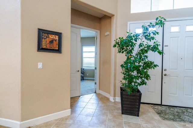 foyer entrance with light tile patterned flooring