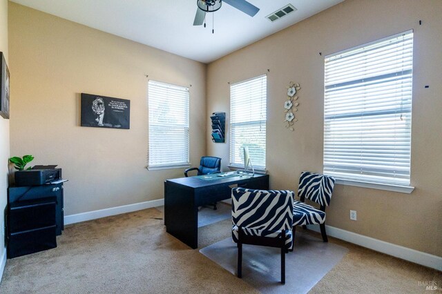 home office featuring light colored carpet and ceiling fan