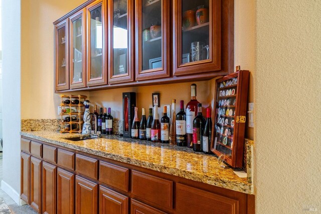 bar with light stone counters and sink