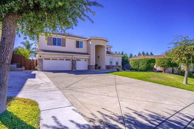 view of front of house featuring a front yard and a garage