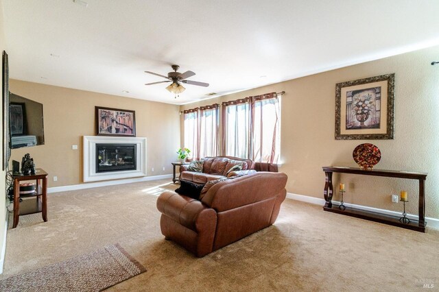 living room with light colored carpet and ceiling fan