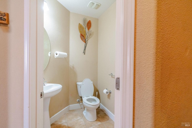 bathroom with tile patterned flooring, toilet, and sink