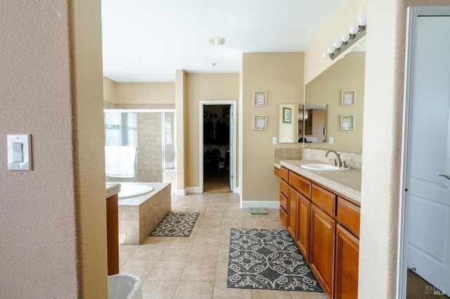 bathroom with tile patterned floors, vanity, and independent shower and bath