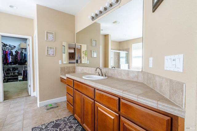 bathroom with tile patterned flooring, vanity, and a shower with shower door