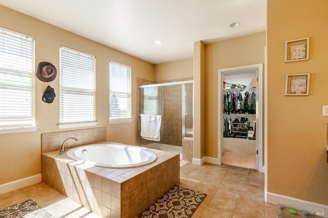 bathroom featuring tile patterned flooring, a healthy amount of sunlight, and plus walk in shower