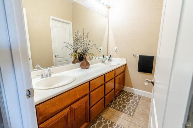 bathroom featuring tile patterned flooring and vanity