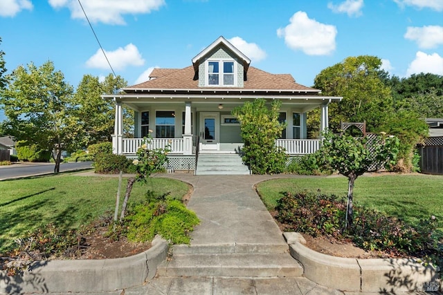 bungalow-style home with covered porch and a front lawn