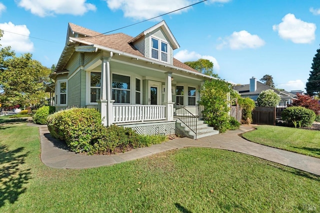 view of front of property with covered porch and a front lawn