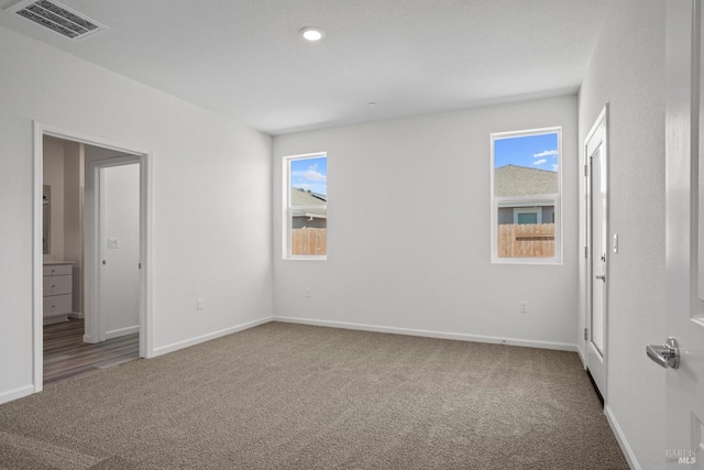 unfurnished bedroom with baseboards, visible vents, and carpet flooring