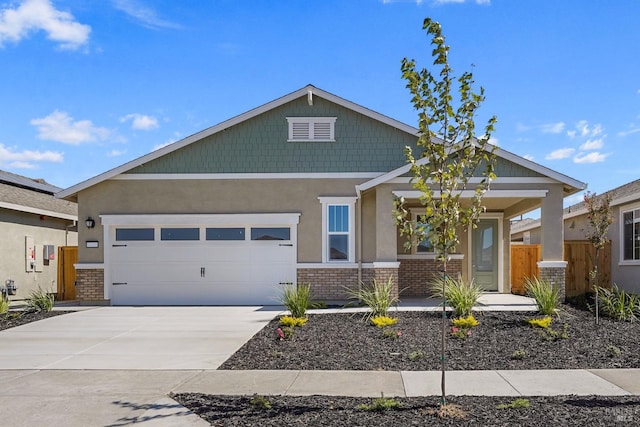 craftsman house with a garage, concrete driveway, brick siding, and fence