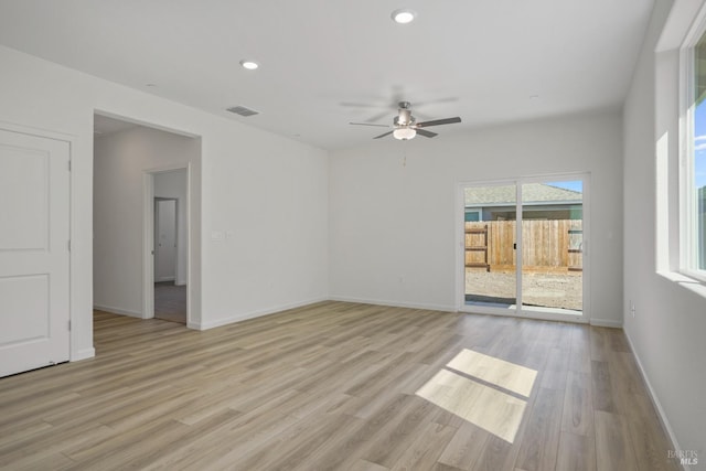 spare room with light wood-type flooring and ceiling fan