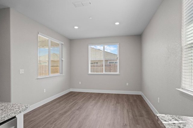 interior space featuring recessed lighting, wood finished floors, visible vents, and baseboards