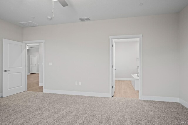 unfurnished bedroom with light carpet, visible vents, ceiling fan, and baseboards