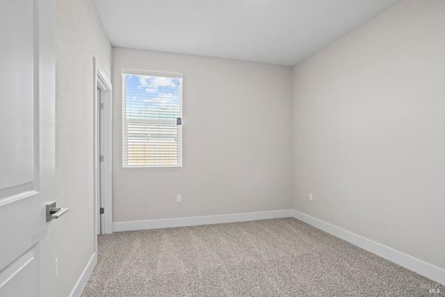 unfurnished room featuring baseboards and carpet floors