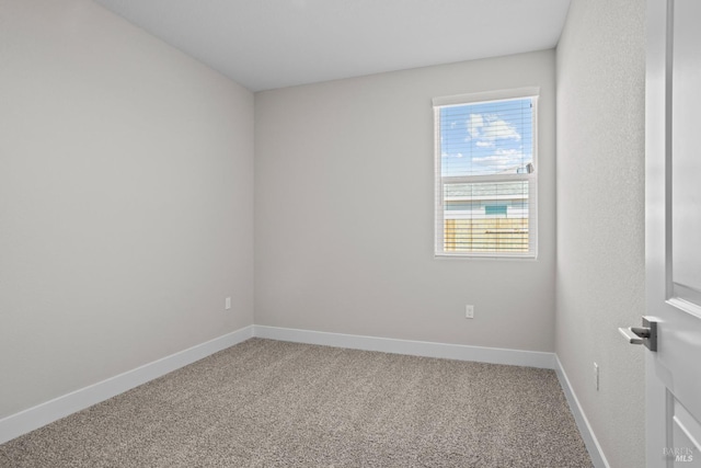 carpeted spare room with baseboards