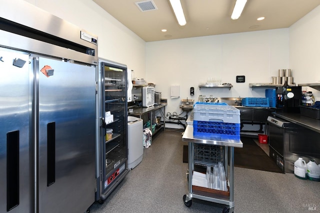 kitchen with recessed lighting, stainless steel fridge, and visible vents