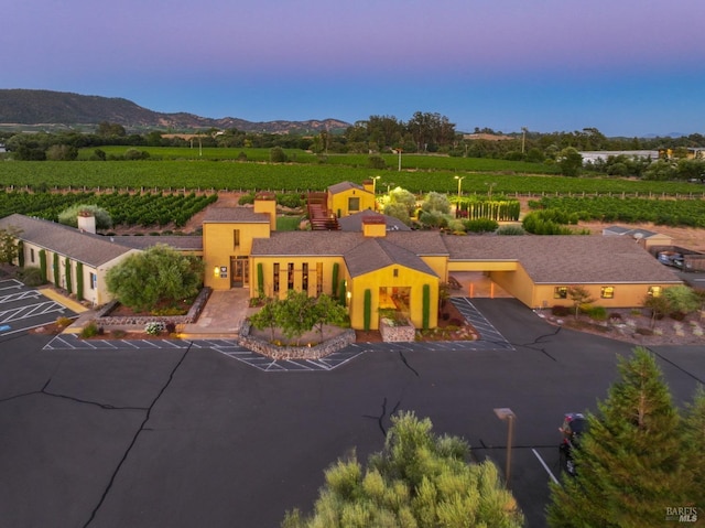 view of front of home featuring uncovered parking, a mountain view, and stucco siding