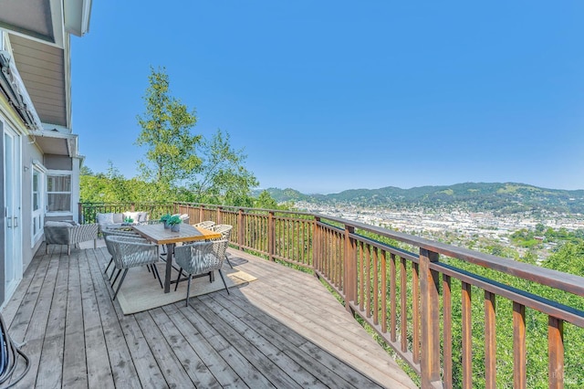 wooden deck featuring a mountain view and outdoor lounge area