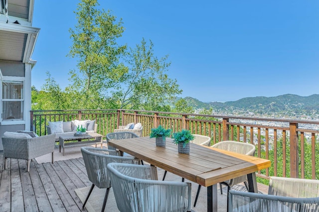 deck featuring a mountain view and an outdoor hangout area