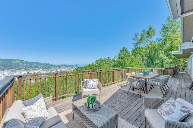 deck with a mountain view and outdoor lounge area